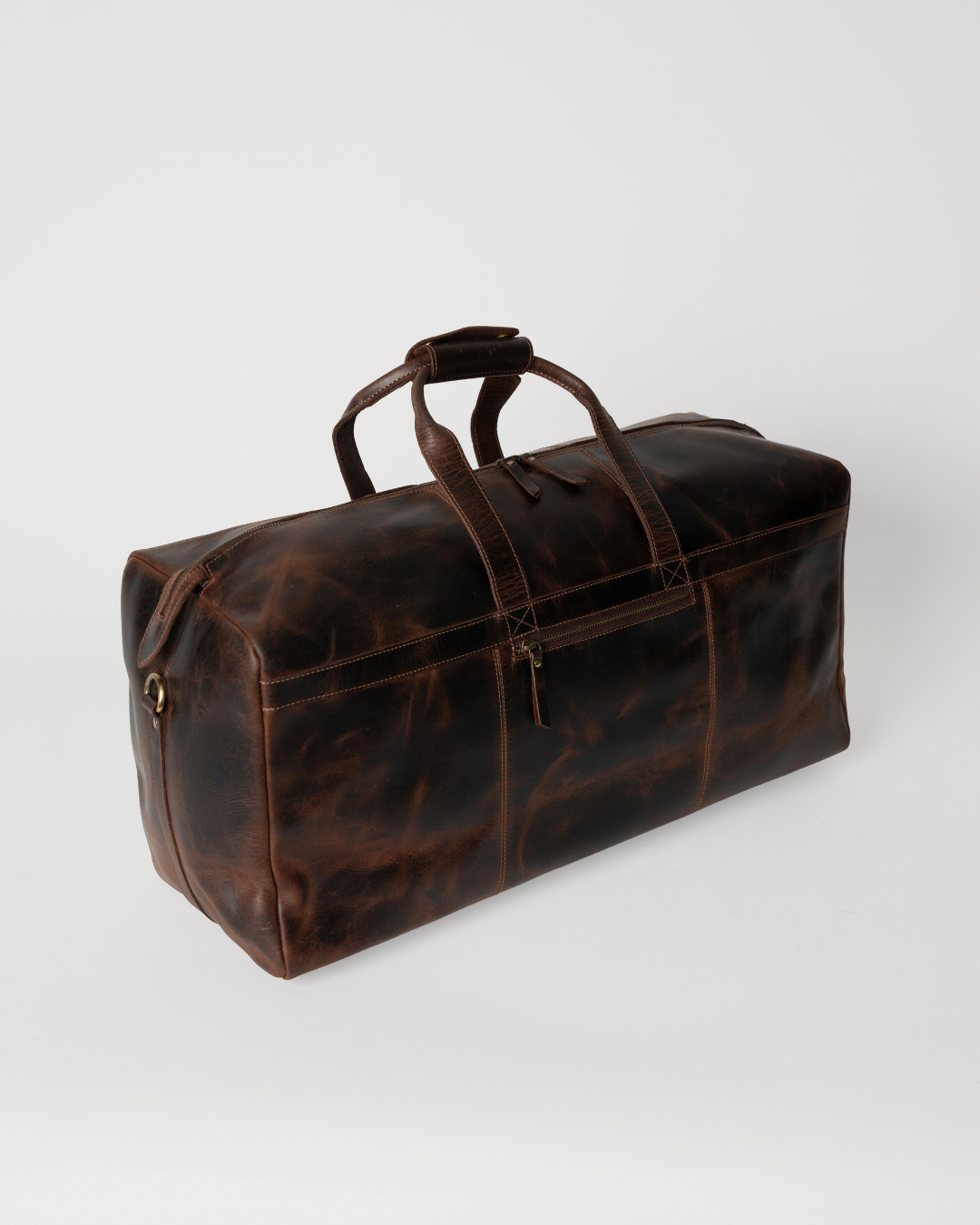 Angled top view of the Laylowe Rowan dark brown leather duffle showing its long zip opening and rectangular shape.