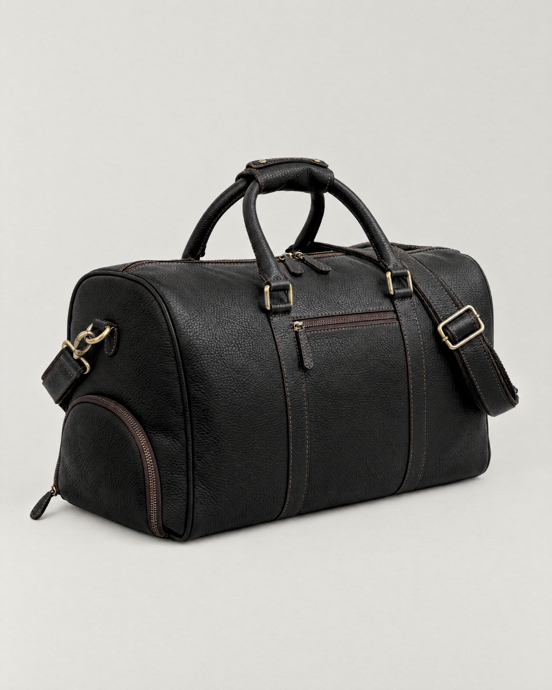 Laylowe Blake black full-grain leather duffle with a front zip pocket, carry handles and shoulder strap.