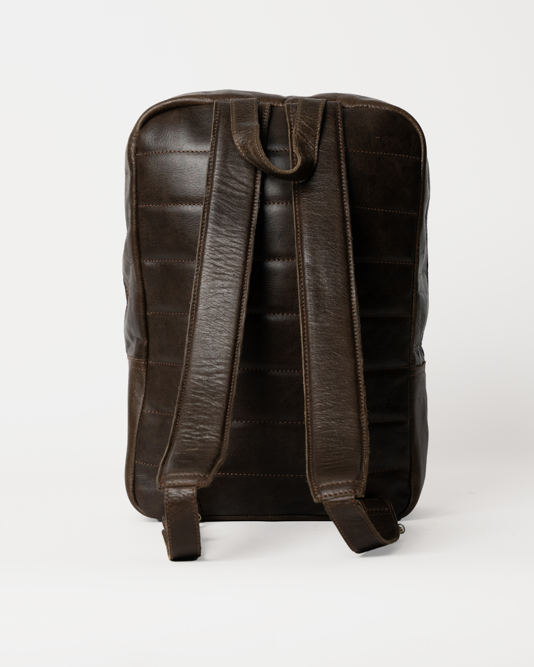 Rear view of the Laylowe Lane dark brown leather backpack showing padded shoulder straps and a top grab handle.