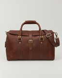 Front view of the Laylowe Parker tan leather weekender showing its buckled flap and rolled carry handles.