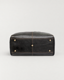Base of the Laylowe Ellis charcoal leather garment duffle showing five metal feet and a central seam.