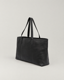 Laylowe Arden black leather tote bag, three-quarter view showing the side panel, stitching and shoulder handles.