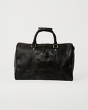 Front view of the Laylowe Beck dark brown small leather duffle with a slip pocket and wrapped carry handles.