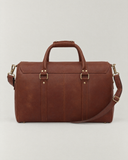 Rear view of the Laylowe Parker tan leather weekender showing its leather panels, carry handles and shoulder strap.