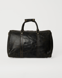 Rear view of the Laylowe Beck dark brown small leather duffle showing vertical handle straps and stitched panels.