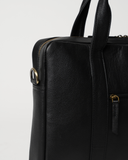 Laylowe Nolan black leather laptop case detail showing the shoulder-strap ring, top zipper and pebbled leather.