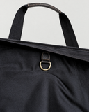 Close-up of the Laylowe Ellis leather garment duffle interior showing dark lining and the metal hanging ring.