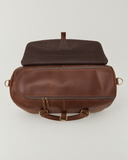 Top view of the Laylowe Parker tan leather weekender with its outer flap folded back to reveal the zip opening.