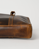 Bottom view of the Laylowe Reid brown leather briefcase showing its slim base and stitched leather corners.