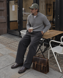Laylowe Grant brown leather briefcase standing beside a man drinking coffee outside a cafe.