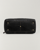 Base of the Laylowe Blake black leather duffle showing five metal feet and stitched panels.