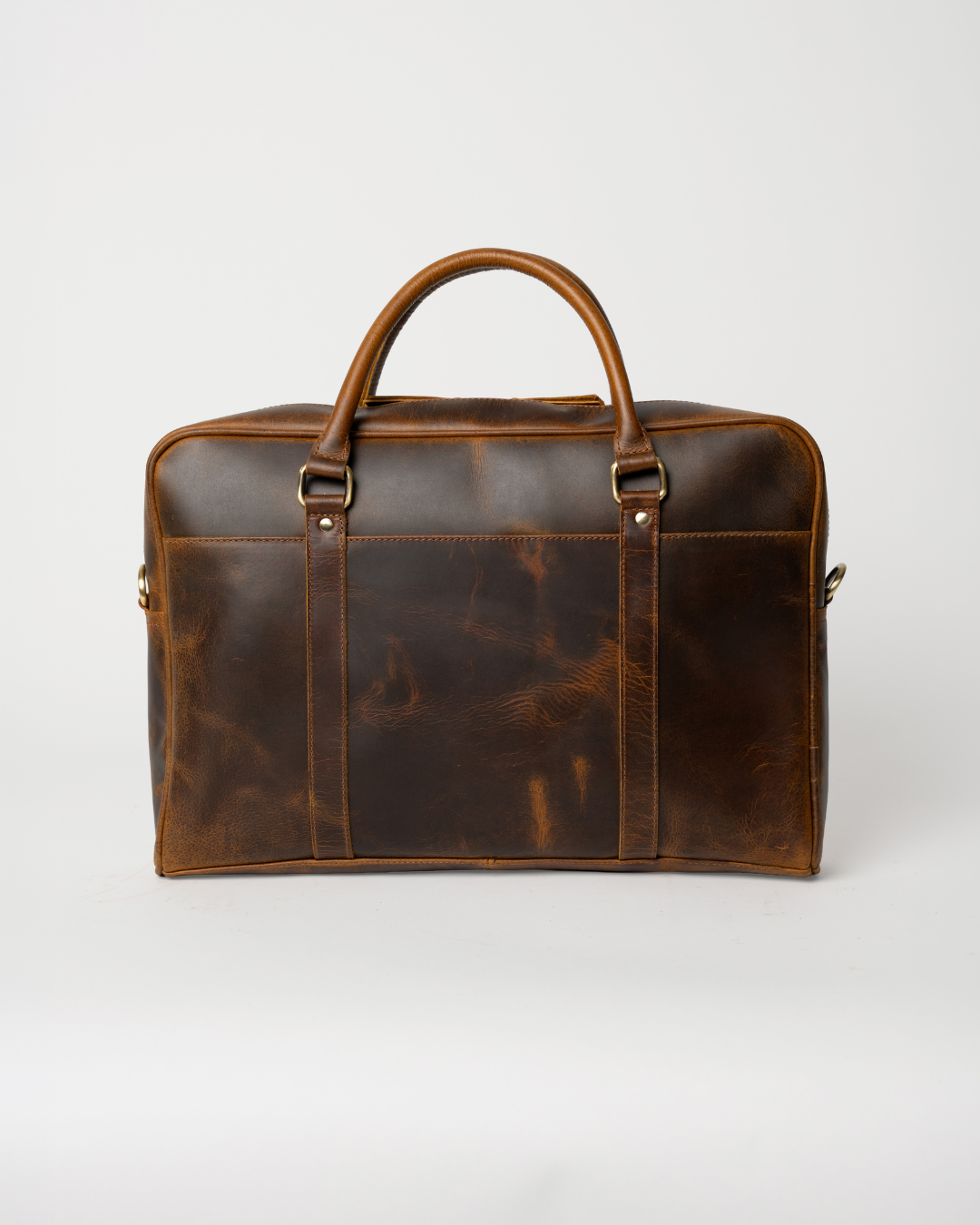 Laylowe Reid dark brown full-grain leather briefcase showing its slim shape, rolled handles and vertical leather straps.