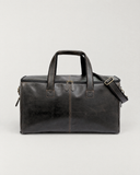 Front view of the Laylowe Ellis charcoal leather garment duffle showing twin handles and a double top zipper.