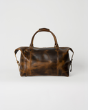 Rear view of the Laylowe Hayes light brown leather weekender, showing its leather panels and carry handles.