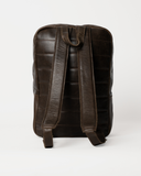 Rear view of the Laylowe Lane dark brown leather backpack showing padded shoulder straps and a top grab handle.